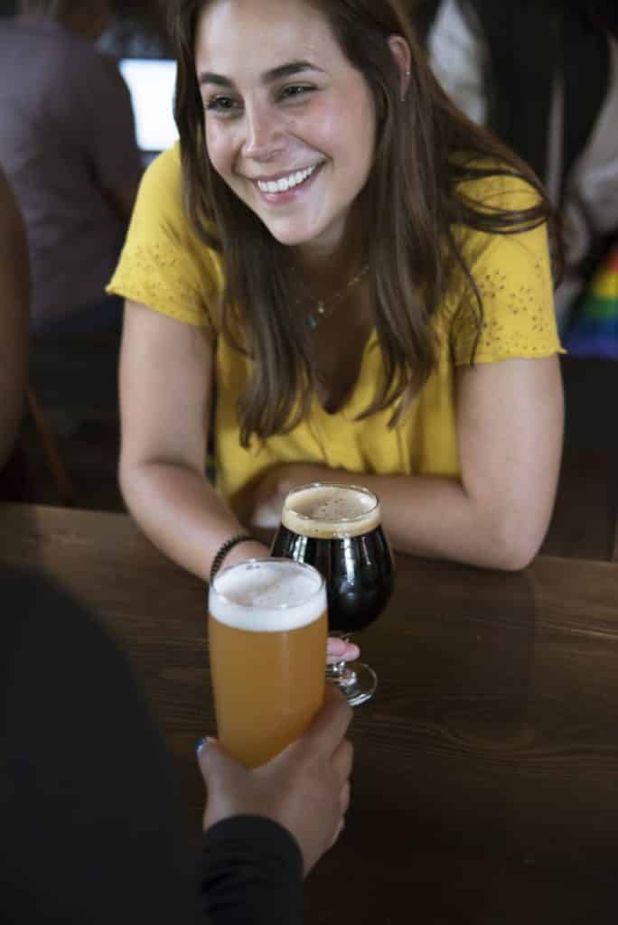 smiling woman drinking beer