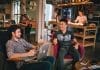 Friends chatting indoors while sitting in armchairs