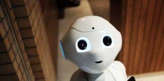 A white robot looks upwards