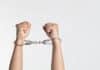 A pair of handcuffed hands