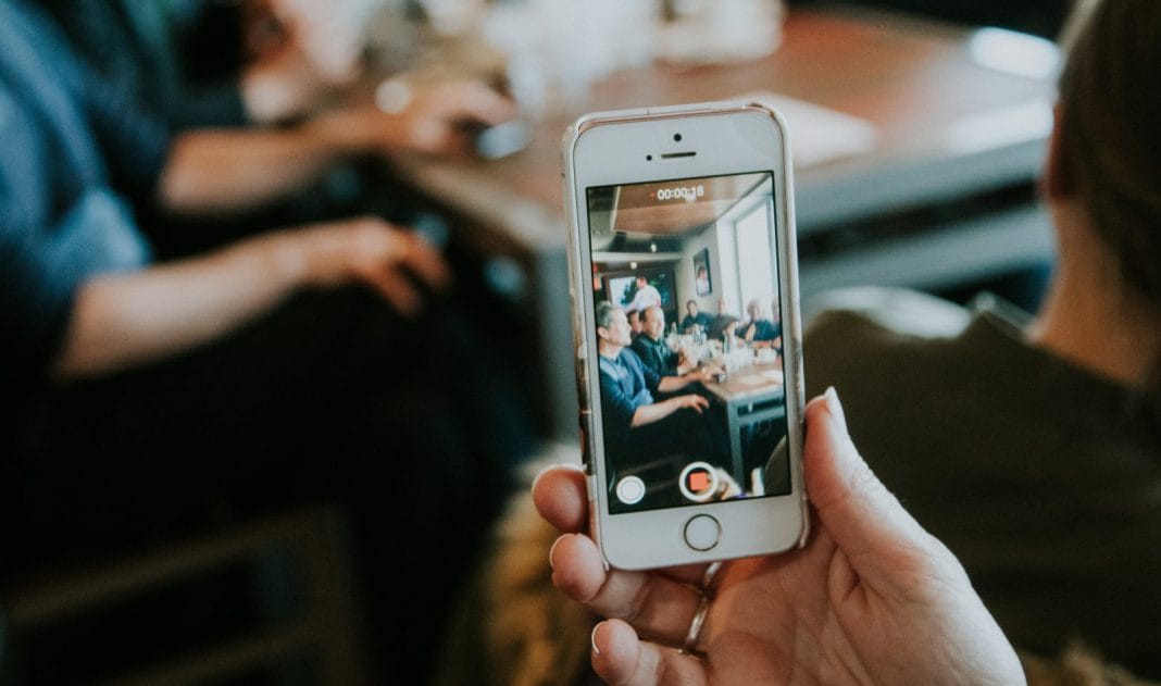 A person videoing themselves on their phone
