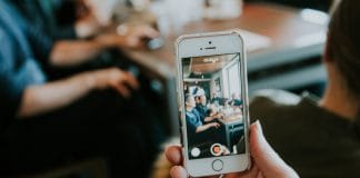A person videoing themselves on their phone