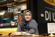 A smiling Muslim student