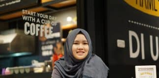 A smiling Muslim student