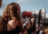 A student holds a microphone at a protest