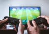 Two people play on a Playstation