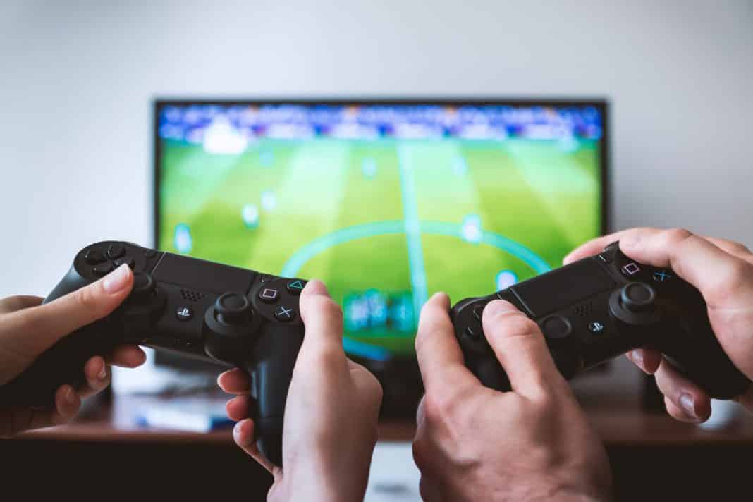 Two people play on a Playstation