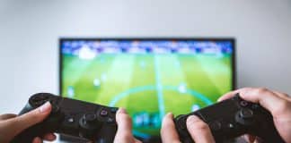 Two people play on a Playstation