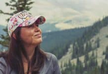 Standing in front of tree-covered mountains, a Mexican woman smiles