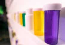 Empty medicine bottles on a shelf