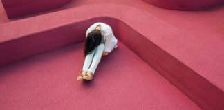 Person curled up on the floor in despair