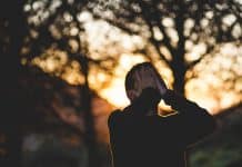 A man covers his face with his hands