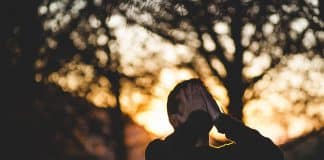 A man covers his face with his hands