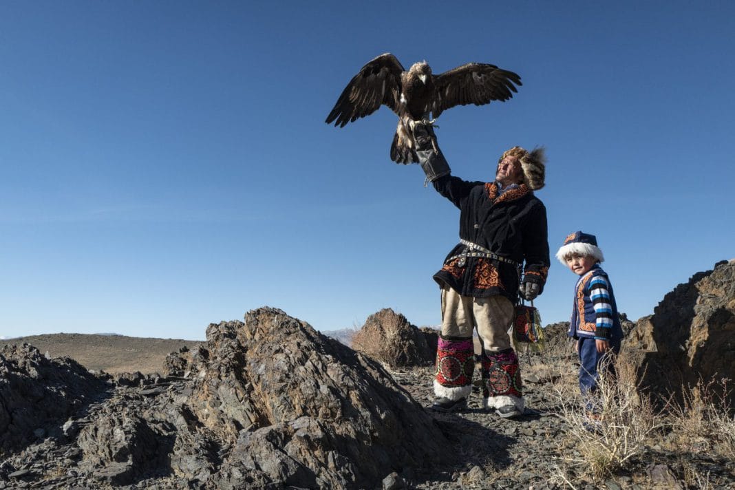 A man holding an eagle in Mongolia