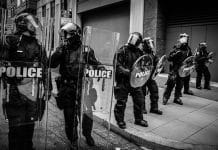 Police holding up shields