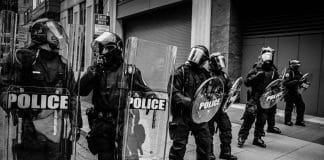 Police holding up shields