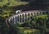 A train travelling across a curved bridge
