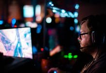 A man with a headset plays e-sports