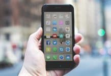 A phone with a variety of social media apps on the screen.