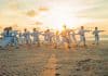 A group of people performs Tai Chi outside