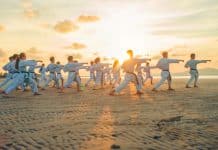 A group of people performs Tai Chi outside