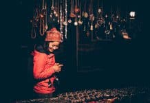 A young Asian woman looks at jewellery on a stall