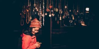 A young Asian woman looks at jewellery on a stall
