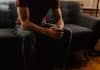 A man sitting on a chair with his hands together