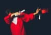 A student dabs in their graduation outfit