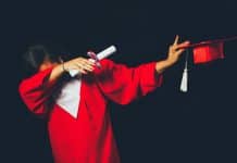 A student dabs in their graduation outfit