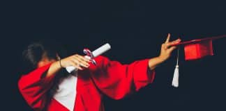 A student dabs in their graduation outfit