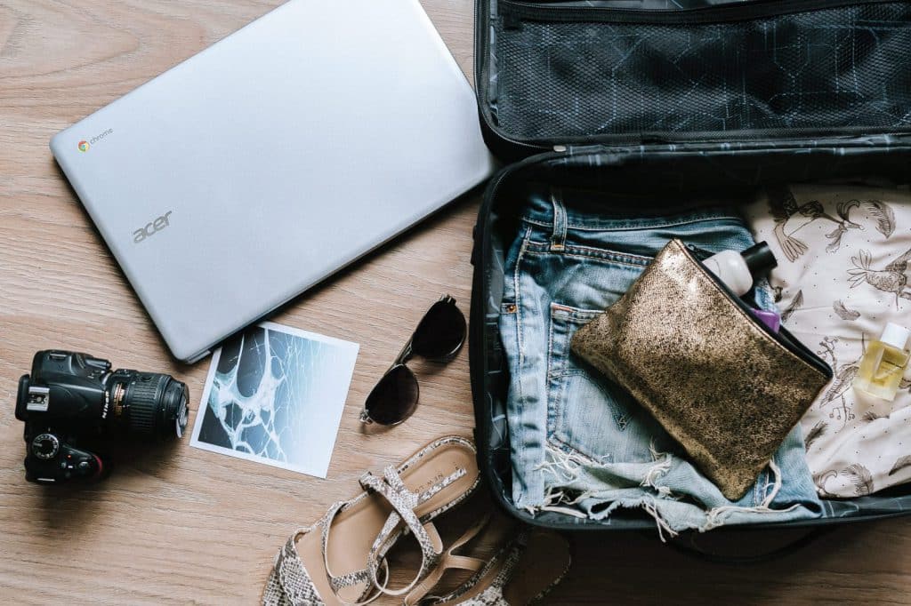 An open suitcase filled with items