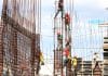 Construction workers assemble a building