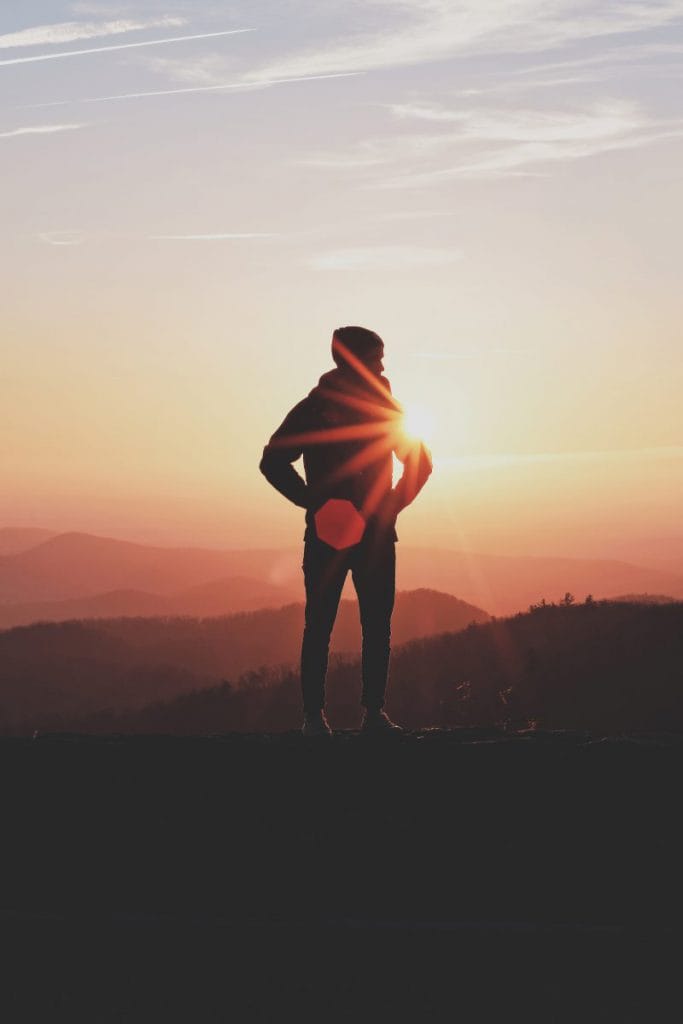 A man faces the sunset alone