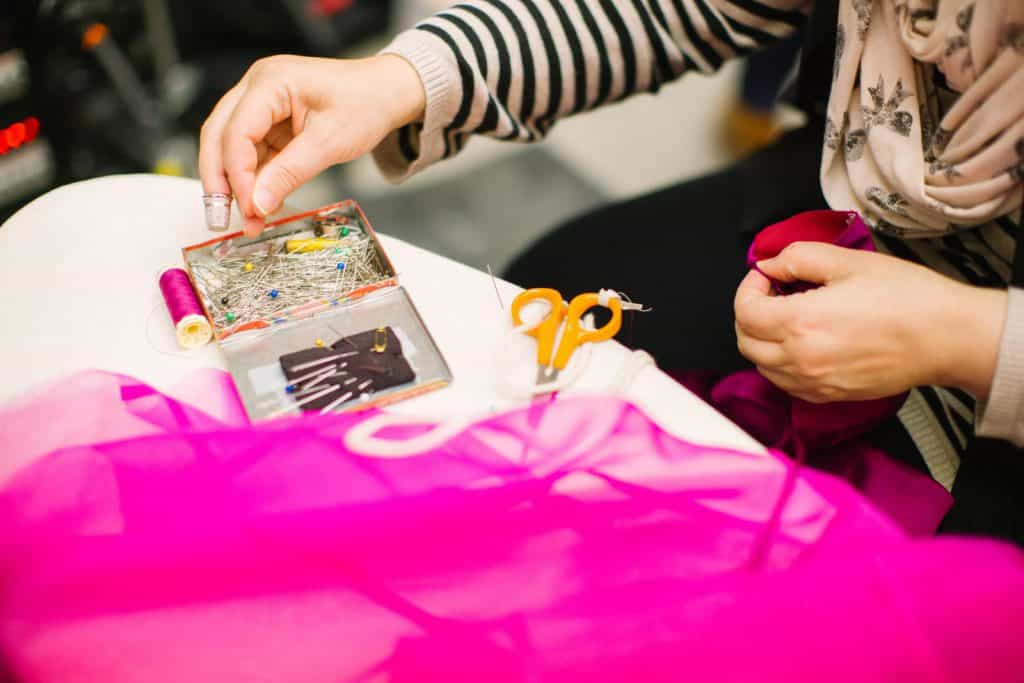 A design student pins a garment together