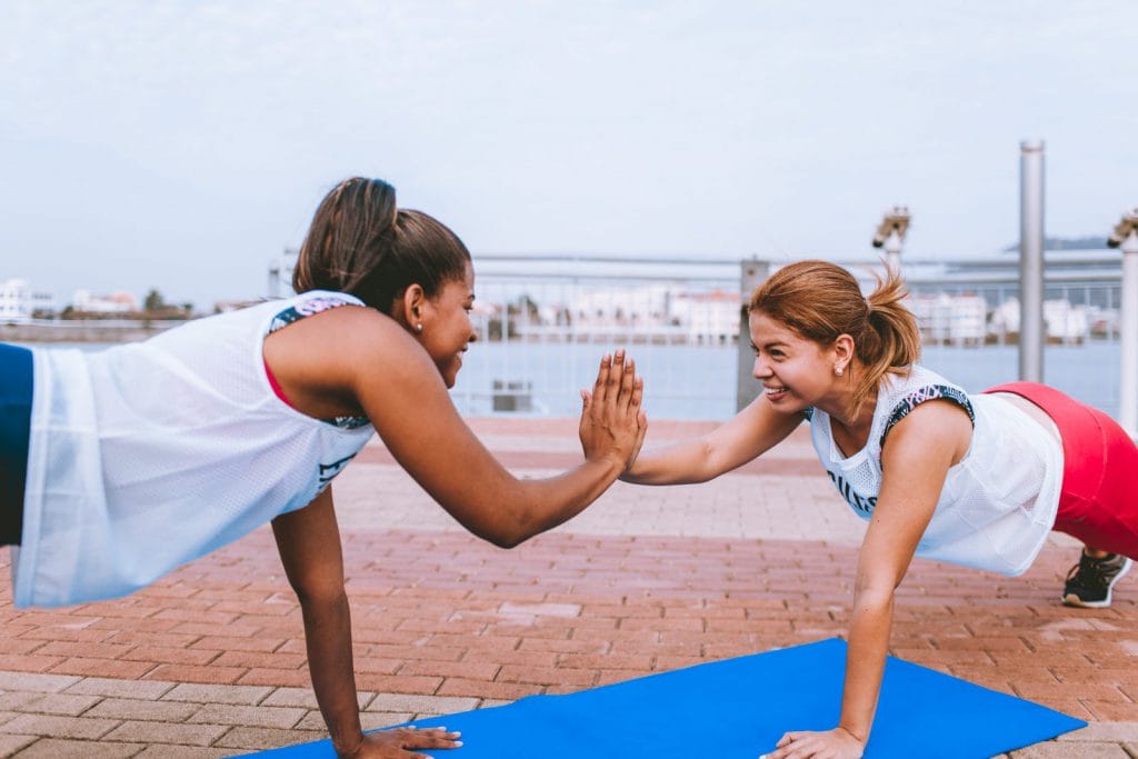 Girls exercising high-five each other