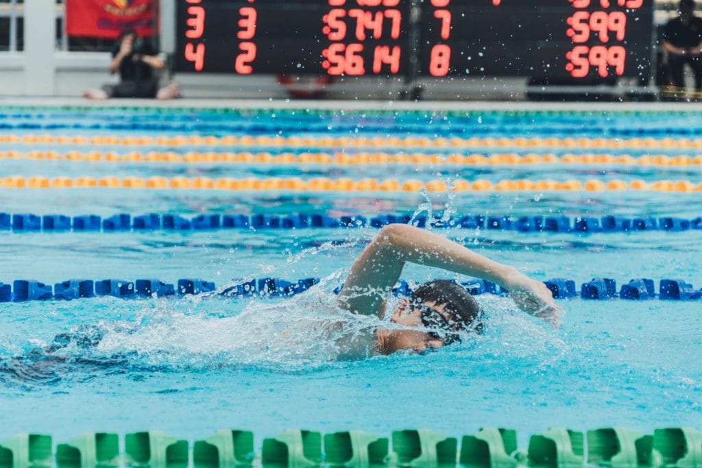 A person swims in a swimming pool