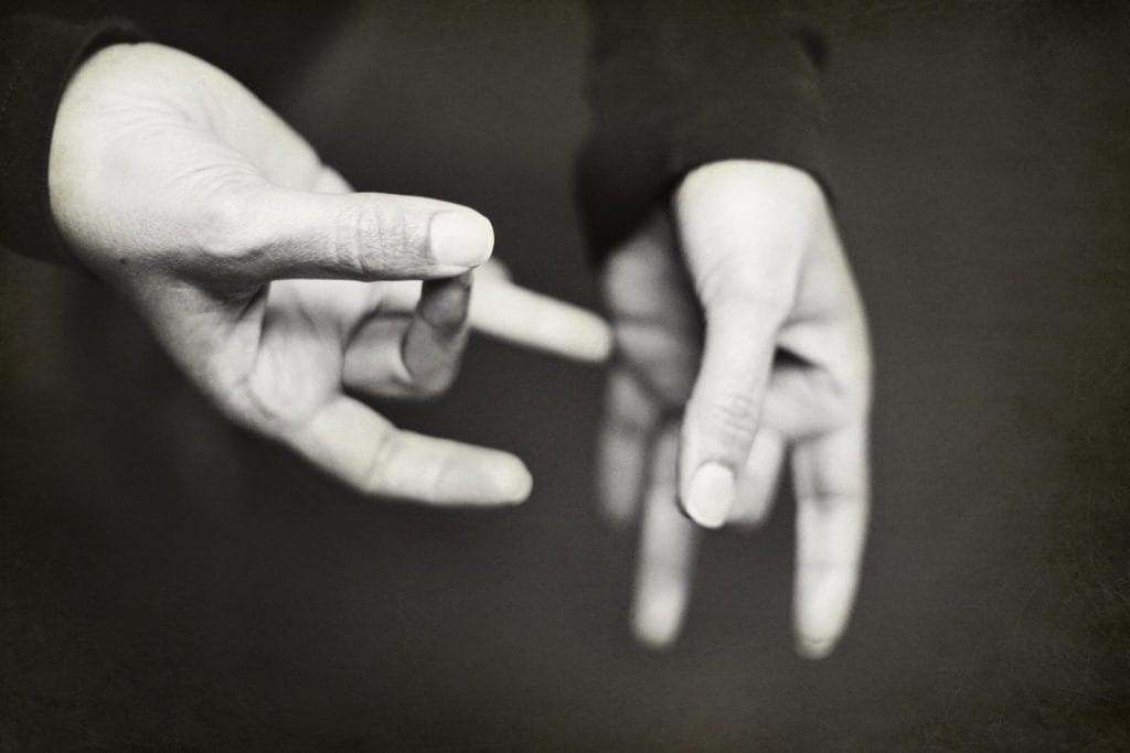 Two hands perform sign language
