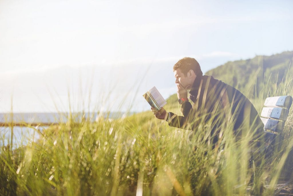 A student reads a book outside