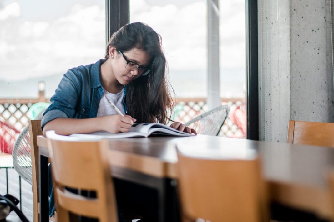 A young woman studies at a table