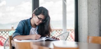 A young woman studies at a table