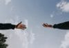 A hand reaches out to another hand