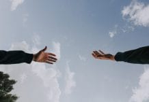 A hand reaches out to another hand