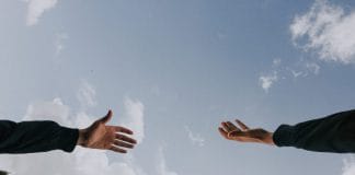 A hand reaches out to another hand