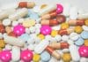 A selection of brightly coloured pills laid out on a surface