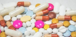 A selection of brightly coloured pills laid out on a surface