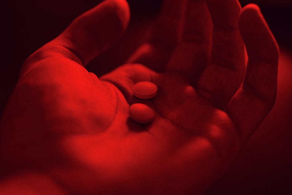 A hand holds some pills