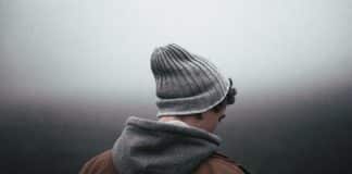 A man, turned away from the camera, looks sad