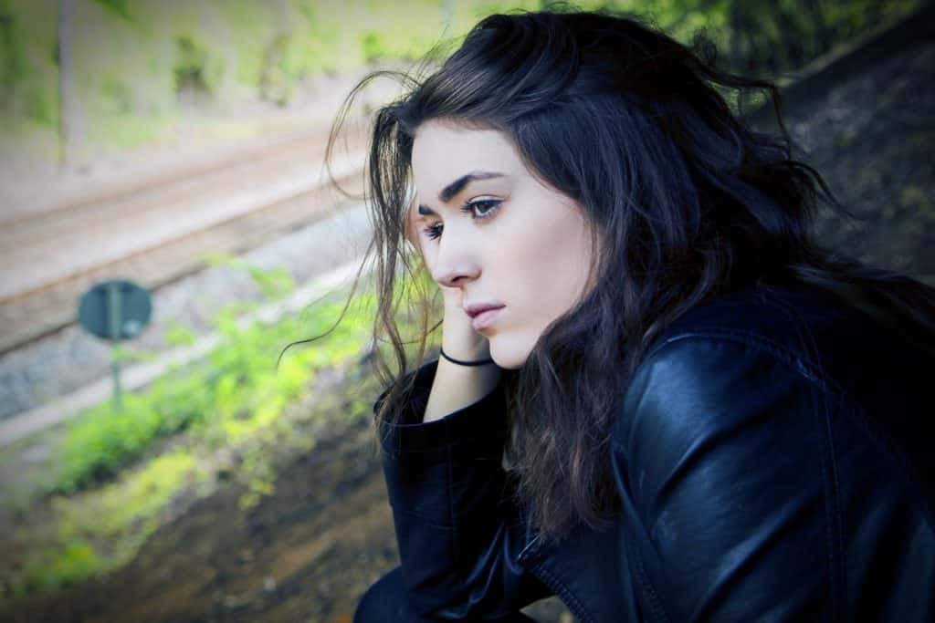 A young woman looks unhappy