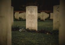 A white grave in a gloomy graveyard
